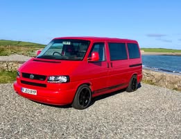 Red Volkswagen T4 by the coast
