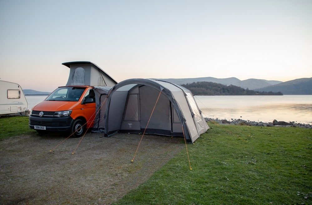 VW campervan with a drive-away awning at a campsite